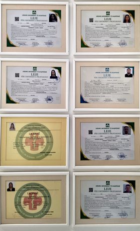 Framed professional licences on the wall of the Creadent clinic, real photo