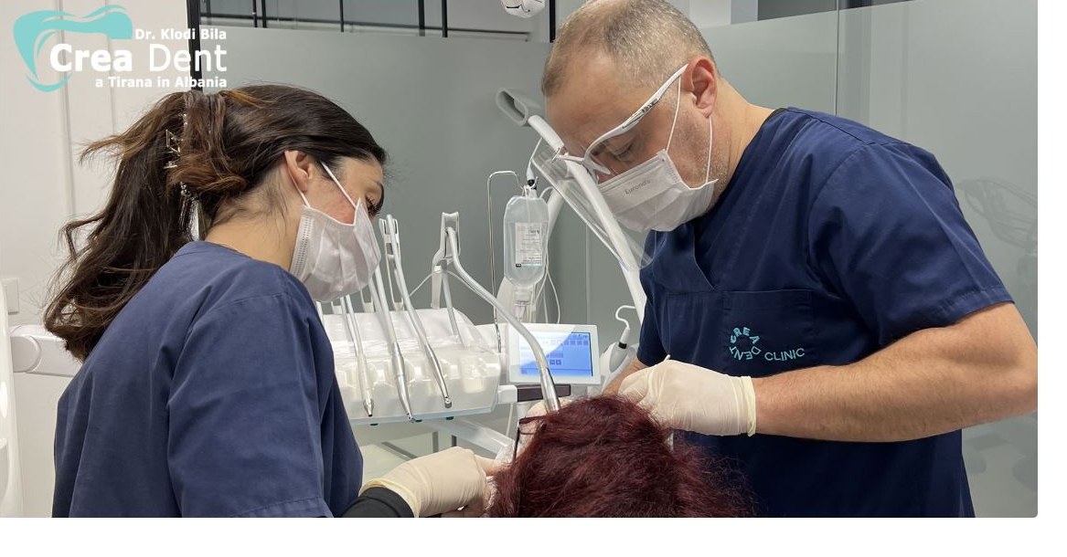 Dr. Klodian Bila during implant surgery at Creadent Clinic