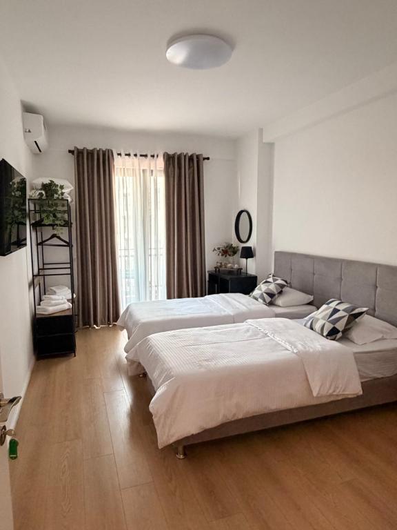 Large bedroom with balcony and city views